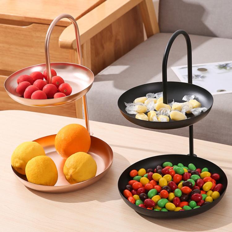 Two-tier wrought iron serving tray pair with arched handles holding fruit and snacks