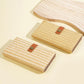 Beige straw-weave long wallet clutch with brown snap tab, shown in two angles