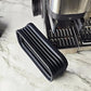 Black ridged air blower nozzle positioned near an espresso machine