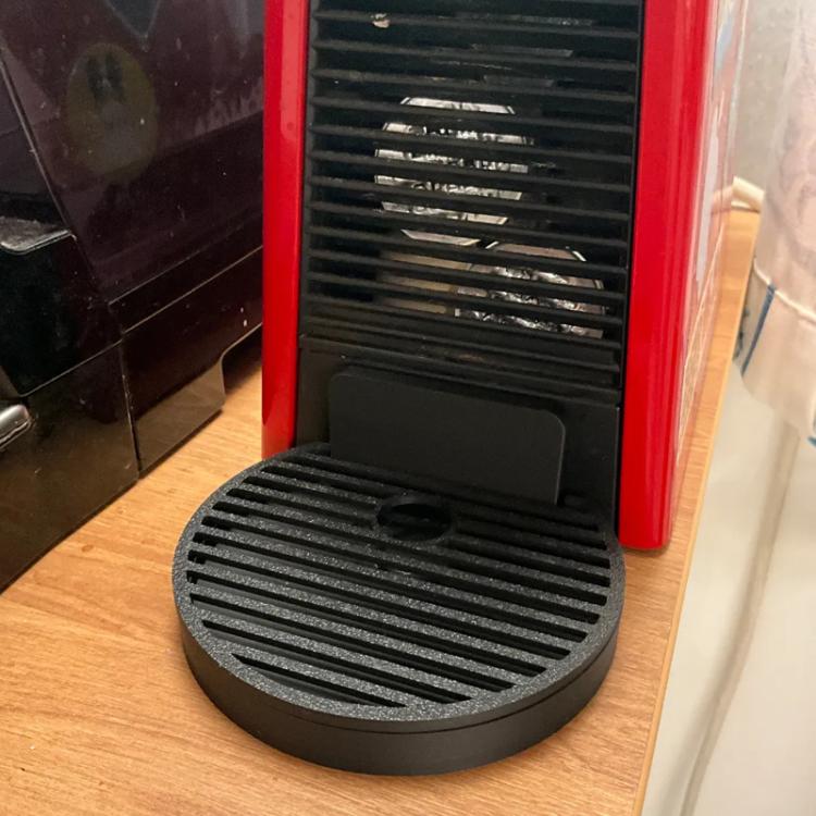 Black low-profile cup stand base with ridged grate and round drain opening