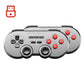 Wireless game controller angled view with dual joysticks and red ABXY face buttons