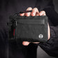 Black RFID card holder wallet held in hand with red-accent zipper