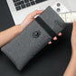 Gray foldable pouch with snap button and drawstring, held in hand