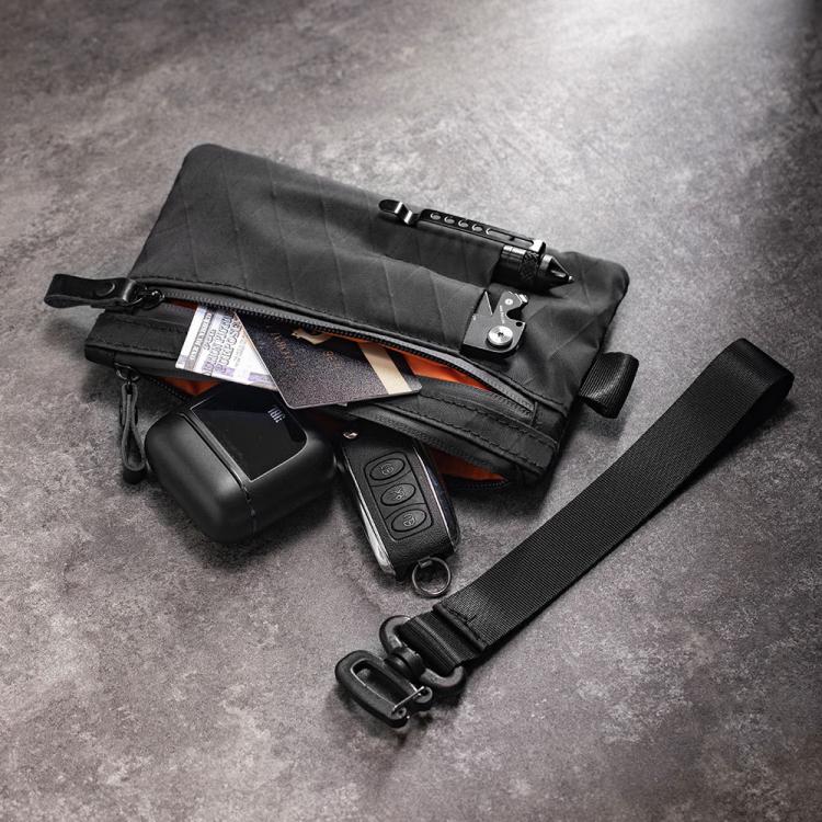 Black RFID-blocking card wallet opened with cards and small keychain items inside
