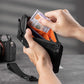 Black RFID-blocking card wallet with hand inserting cash into the zip pocket