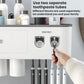 White dual toothpaste dispenser toothbrush holder with hand loading two tubes