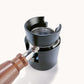Black magnetic dosing ring installed on grinder dosing area with two side tabs.