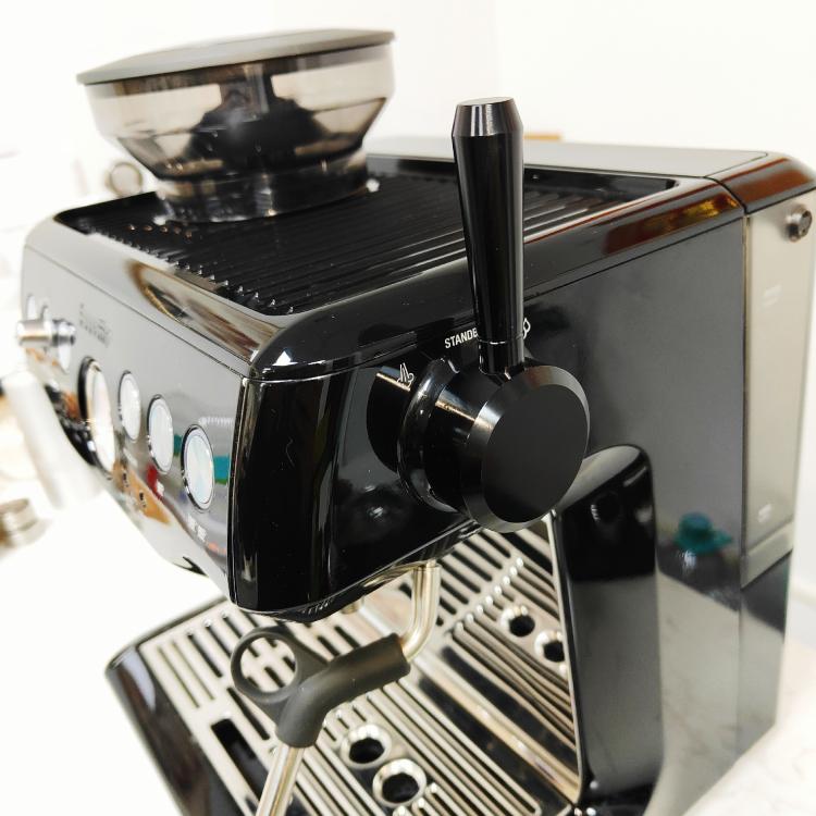 Black external steam switch lever installed on espresso machine front