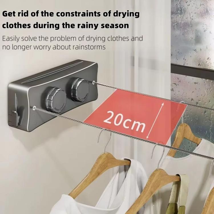 Gray retractable wire clothesline drying rack with hanging clothes on the wire lines