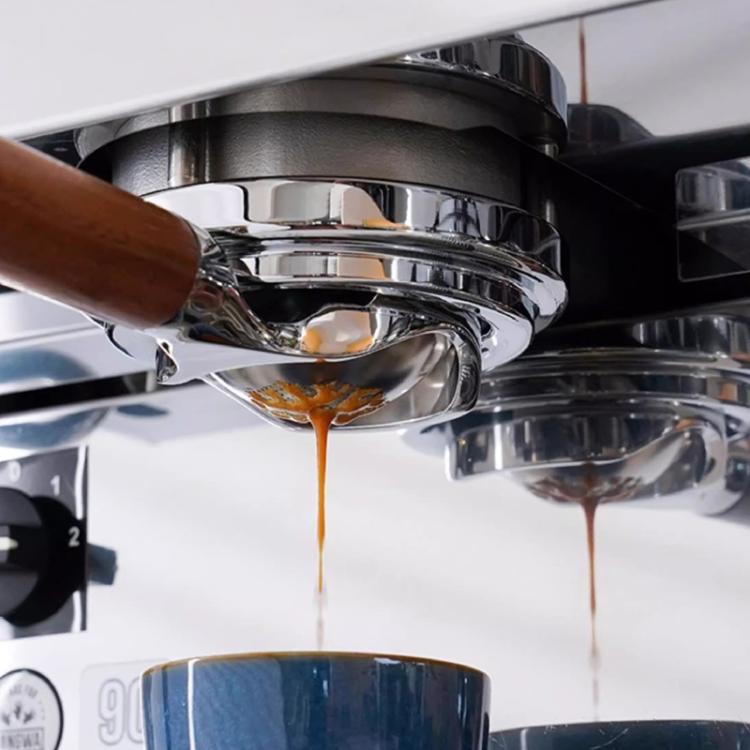 Stainless steel portafilter basket with fine mesh perforations under the spout
