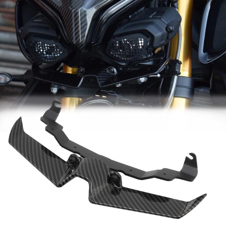 Carbon fiber bird beak lower headlight fairing spoiler with textured weave and tabs.