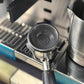 Backflush disk inside portafilter basket on espresso machine, dark gray rubber