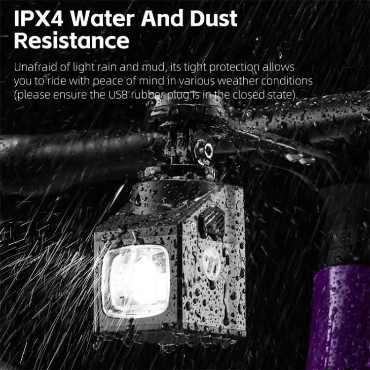 Black waterproof bicycle front light shown with water droplets