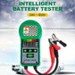 Green handheld battery tester with LED display and attached red/black clamp leads
