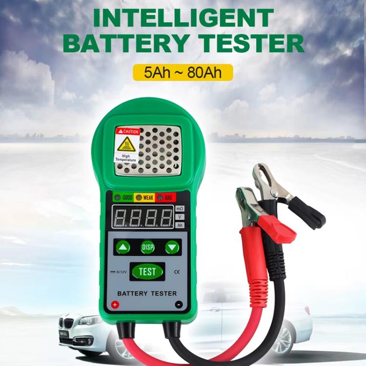 Green handheld battery tester with LED display and attached red/black clamp leads
