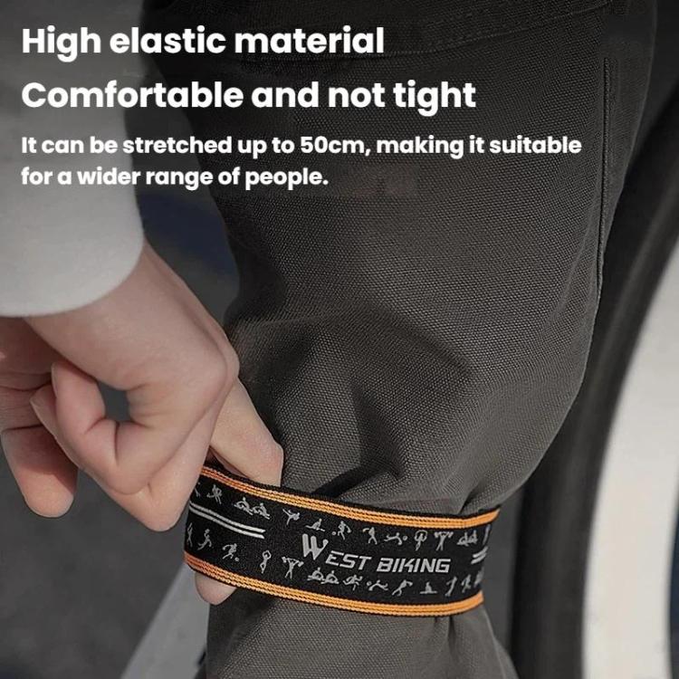 Adjustable reflective pant strap band around gray pant leg, black band with orange edge