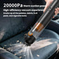 Black handheld cordless vacuum cleaner nozzle clearing debris on a car seat