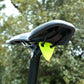 Neon green reflective triangle sticker mounted on bicycle seat area