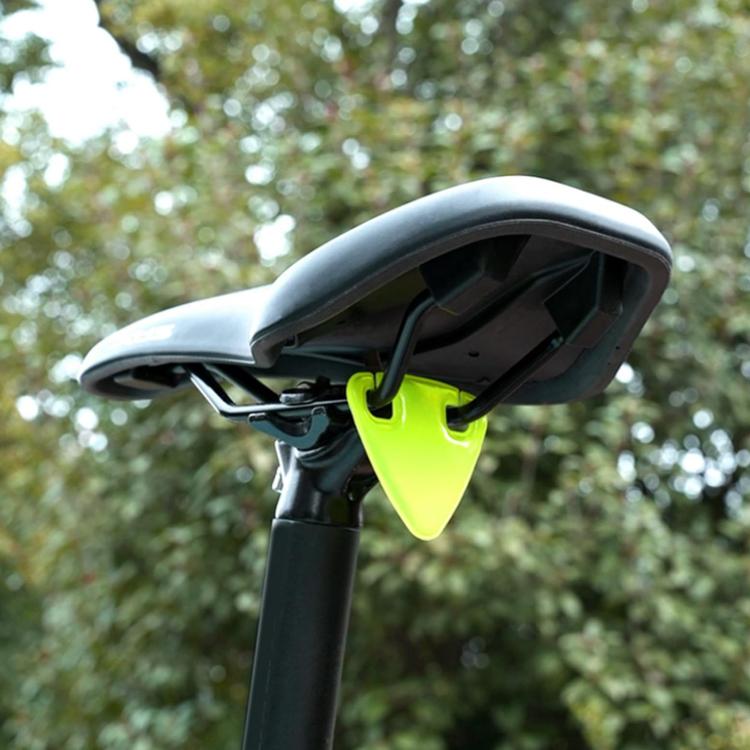 Neon green reflective triangle sticker mounted on bicycle seat area