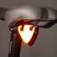 Red reflective triangle bicycle sticker lit for night visibility on rear
