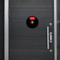 Round black adhesive door sign disc on door: Do Not Disturb message.