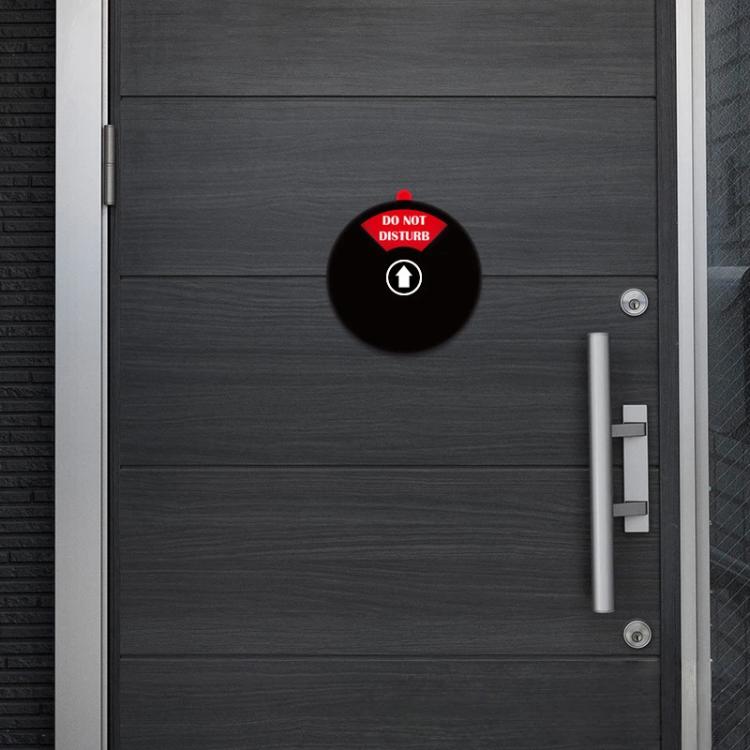 Round black adhesive door sign disc on door: Do Not Disturb message.