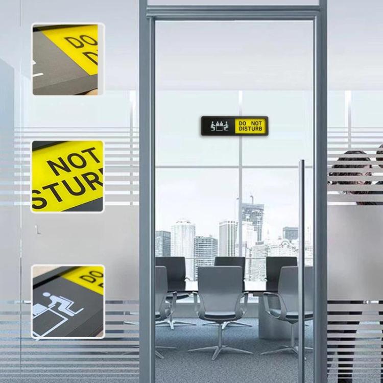 Sliding office sign on glass door with DO NOT DISTURB message and yellow panel