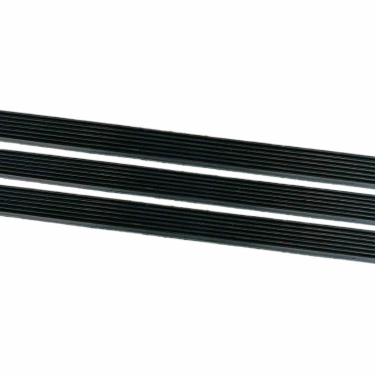 Close-up of black multi-V belt ribs with parallel ridged drive surface