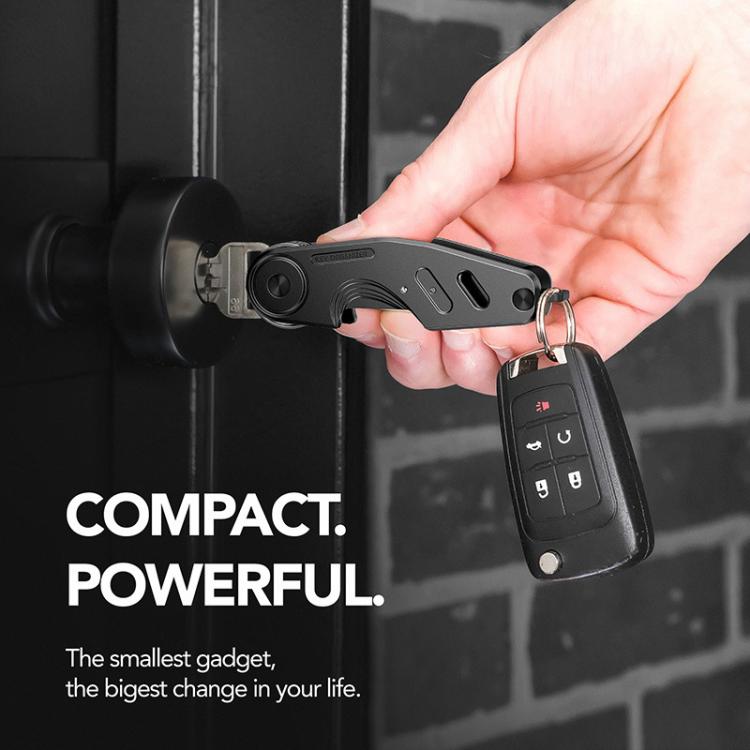 Black aluminum key holder clip with key ring held in a hand