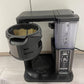 Black mesh filter basket on coffeemaker base, front view