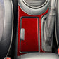 Red carbon-fiber cupholder sticker set installed beside gear selector, left-hand drive