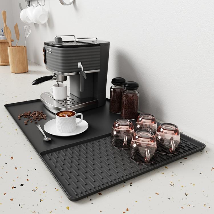 Black silicone draining tray mat with raised horizontal ridges for coffee machine