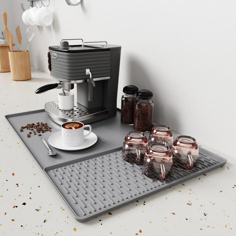 Gray silicone draining tray mat with raised horizontal ridges for coffee machine