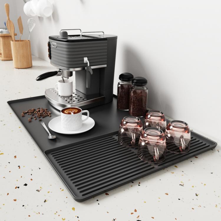 Dark gray silicone draining tray mat with raised horizontal ridges for coffee machine