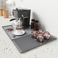 Light gray silicone draining tray mat with raised horizontal ridges for coffee machine