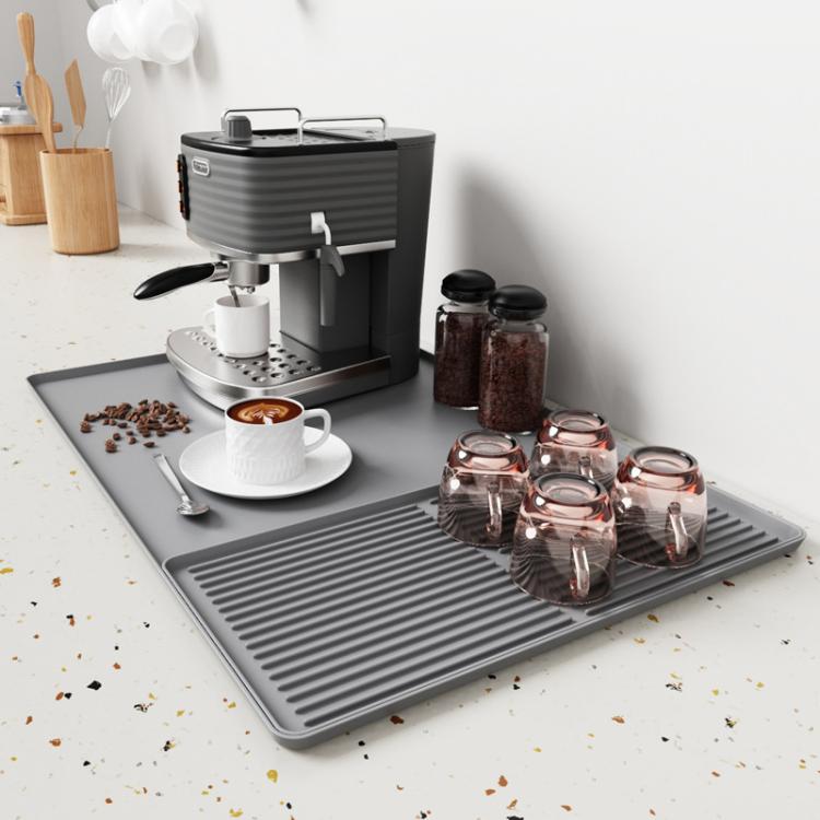 Light gray silicone draining tray mat with raised horizontal ridges for coffee machine