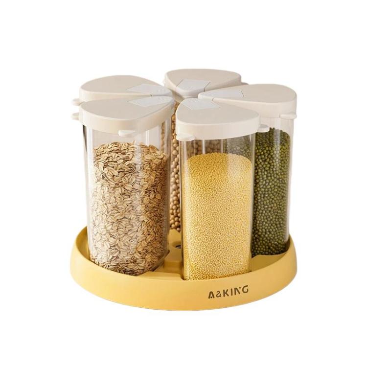 Rotatable cereal storage container with clear jars filled with grains, white lids and yellow base