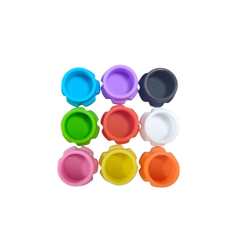 Assorted reusable insulin bottle caps in colors: blue, purple, dark gray, green, red, white, orange