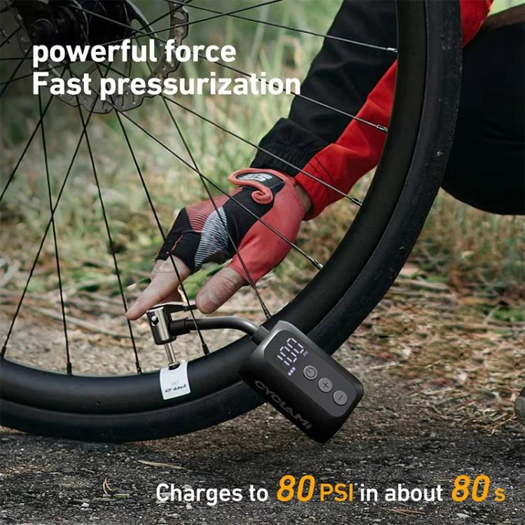 Electric air pump attached to bicycle tire valve with connected hose
