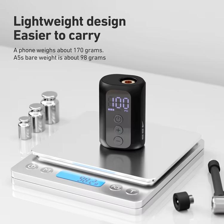 Lightweight electric air pump shown on a scale with valve adapters