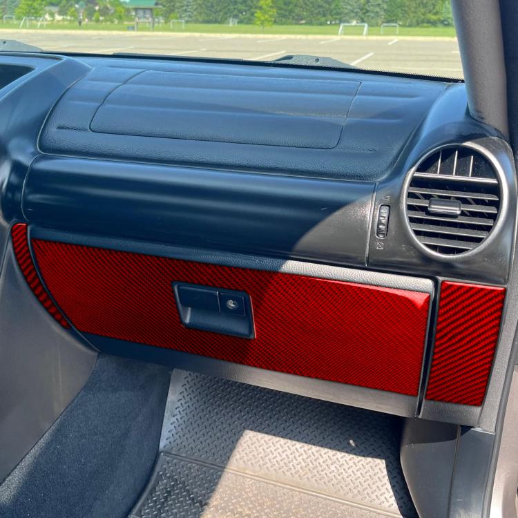 Red carbon-fiber look 3-piece panel sticker set installed on passenger door interior (LHD).