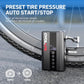Portable air pump with hose nozzle on the ground beside bicycle tires