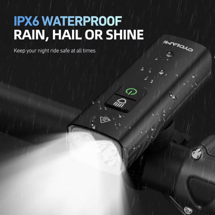 Waterproof rechargeable bike headlight with water droplets on housing and front lens