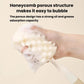Sponge bottle brush head with porous texture for scrubbing inside bottles.