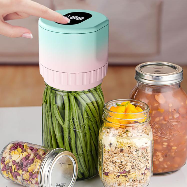 Electric vacuum sealer on mason jars with preserved foods, teal and pink