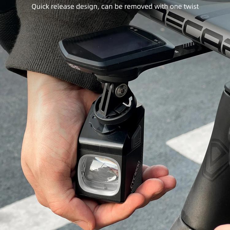 Bicycle front light with quick-release mount, held in hand for attaching