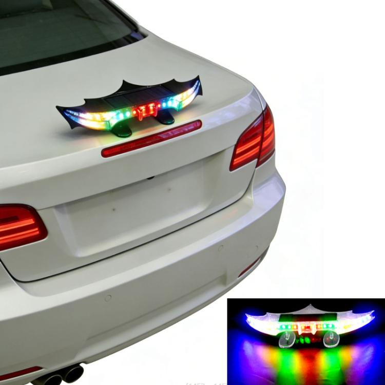 Solar-powered rear wing light mounted on car trunk, flashing multicolor LEDs at night