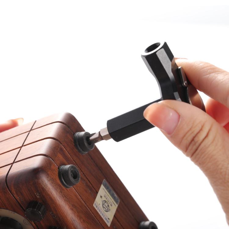 Ratchet screwdriver tightening a screw on a wooden furniture panel