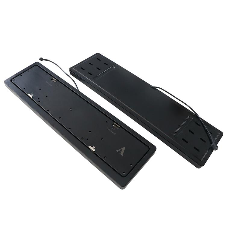 Black electric license plate flip frame housings, two units, viewed from above.