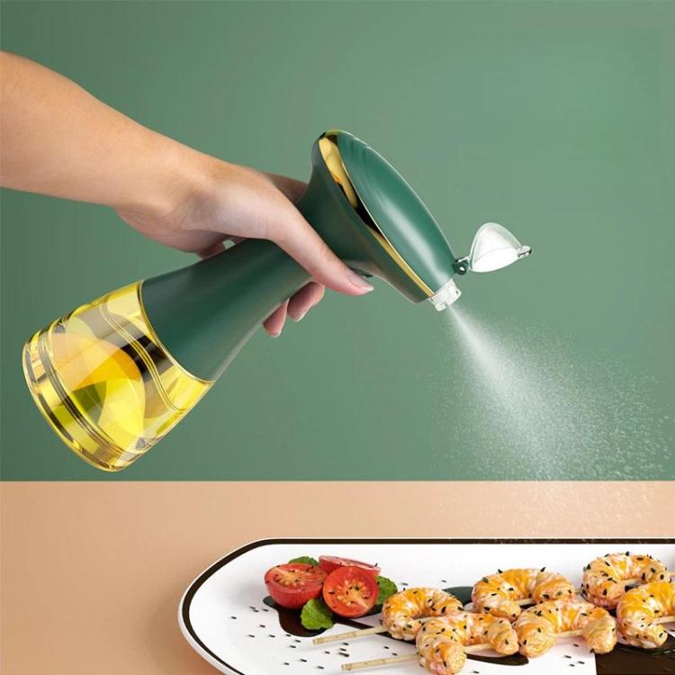 Electric oil sprayer bottle with green body spraying mist from chrome nozzle